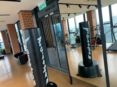 a gym with two black and white signs in a room at Ceylonz Suite Official in Kuala Lumpur