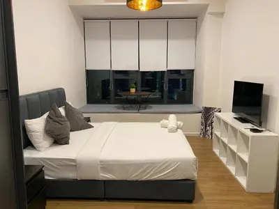 a bedroom with a large bed and a television at Ceylonz Suite Official in Kuala Lumpur