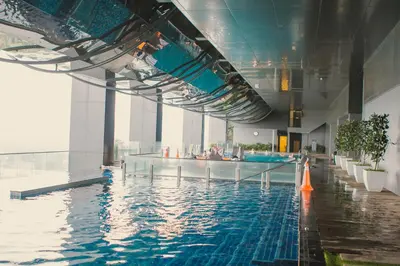 a swimming pool in a large building with water at M City 2 DUPLEX BEDROOM KLCC in Kuala Lumpur