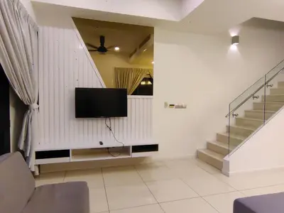 a living room with a flat screen tv on the wall at M City 2 DUPLEX BEDROOM KLCC in Kuala Lumpur