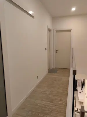 a hallway with white walls and a wooden floor at M City 2 DUPLEX BEDROOM KLCC in Kuala Lumpur