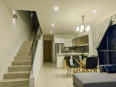 a staircase leading up to a living room and a kitchen at M City 2 DUPLEX BEDROOM KLCC in Kuala Lumpur