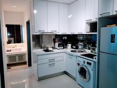 a kitchen with white cabinets and a blue refrigerator at KLCC Gem walk to all in Kuala Lumpur