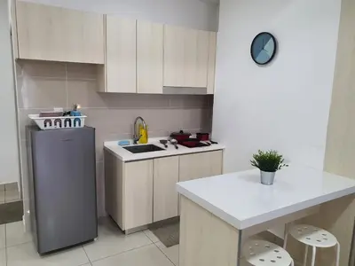 a kitchen with a refrigerator and a sink and a table at Vivo Soho Suite @ Mid Valley Old Klang Road KL in Kuala Lumpur