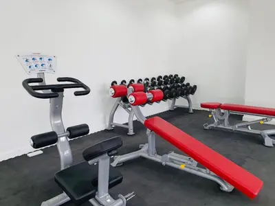 a gym with a row of exercise equipment at Vivo Soho Suite @ Mid Valley Old Klang Road KL in Kuala Lumpur
