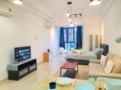 a living room with a couch and a tv at Vivo Soho Suite @ Mid Valley Old Klang Road KL in Kuala Lumpur