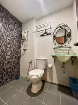 a bathroom with a toilet and a sink at Rae Hotel Bukit Bintang in Kuala Lumpur