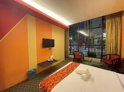 a hotel room with a bed and a television at Rae Hotel Bukit Bintang in Kuala Lumpur