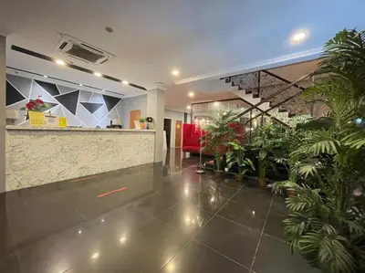 a lobby with plants and a counter in a building at Rae Hotel Bukit Bintang in Kuala Lumpur