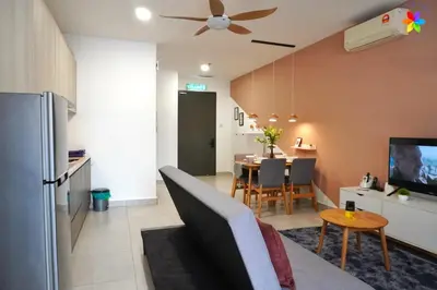 a kitchen and living room with a couch and a table at Lily and Loft - Queensville @ Kuala Lumpur - Netflix in Kuala Lumpur