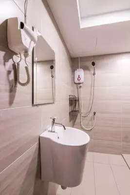 a bathroom with a sink and a mirror at 3 Towers Klcc By Tenang Homes in Kuala Lumpur