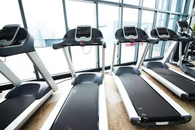 a gym with rows of tread machines in a building at 3 Towers Klcc By Tenang Homes in Kuala Lumpur
