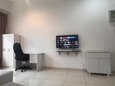 a room with a desk and a monitor on the wall at 3 Towers Klcc By Tenang Homes in Kuala Lumpur