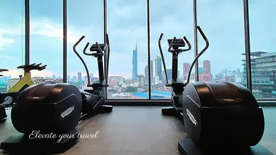 a gym with a view of the city from a skyscraper at Modern Suites 3Beds at Continew, TRX KLCC view, Next to IKEA in Kuala Lumpur