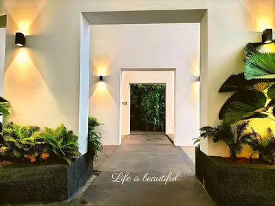 a hallway of a house with a door and plants at Modern Suites 3Beds at Continew, TRX KLCC view, Next to IKEA in Kuala Lumpur