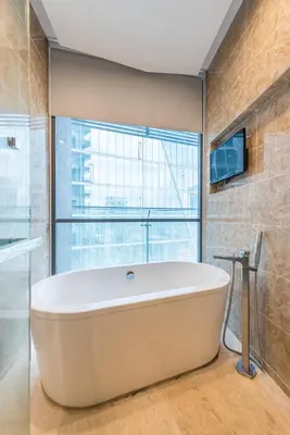 a bath tub in a bathroom with a window at Dorsett Residence Kuala Lumpur 15 in Kuala Lumpur