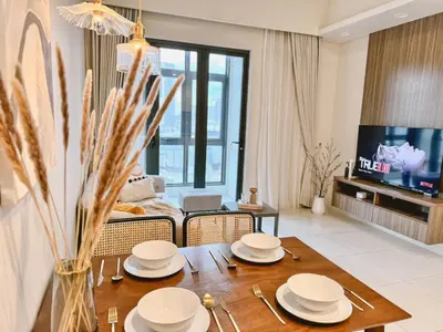 a living room with a dining room table with plates on it at TRX Garden View TriBeCa 3min walk2 Pavillion 2bedroom in Kuala Lumpur