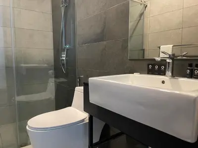 a bathroom with a sink and a toilet and a mirror at Opus Residences Warisan Merdeka by C&C Fortune in Kuala Lumpur