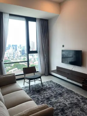 a living room with a couch and a flat screen tv at Opus Residences Warisan Merdeka by C&C Fortune in Kuala Lumpur