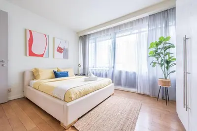 a bedroom with a bed and a large window at 2min walk to Lot 10, 5 min to Pavillion 2BR 8-2 WIFI 100mbps in Kuala Lumpur