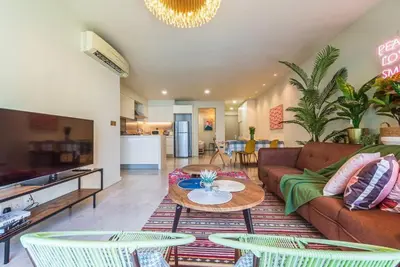 a living room with a couch and a table and chairs at 2min walk to Lot 10, 5 min to Pavillion 2BR 8-2 WIFI 100mbps in Kuala Lumpur