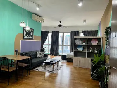 a living room with a couch and a table at Luxury Regalia suites by adnan in Kuala Lumpur
