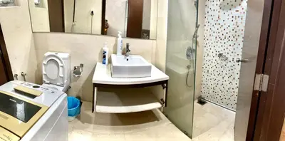 a bathroom with a sink and a toilet and a shower at Luxury Regalia suites by adnan in Kuala Lumpur