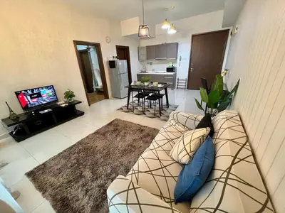 a living room with a couch and a tv at Luxury Regalia suites by adnan in Kuala Lumpur