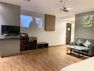 a living room with a couch and a flat screen tv at The Luxmi - Bangsar Trade Centre in Kuala Lumpur