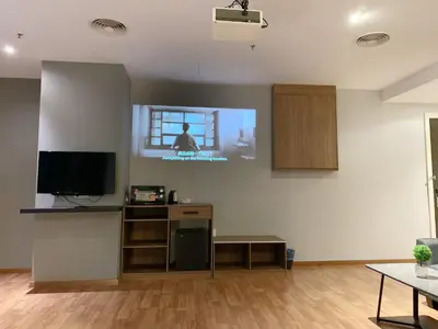 a living room with a flat screen tv on a wall at The Luxmi - Bangsar Trade Centre in Kuala Lumpur