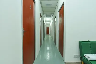 an empty corridor in a hospital room with a corridor at Hotel O Sri Rampai Metro Hostel in Kuala Lumpur