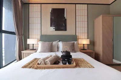 a bedroom with a bed with a teapot on it at Modern Designer Suite at Continew, TRX KLCC View, Next to IKEA in Kuala Lumpur