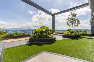 a garden with grass and plants in a building at Continew Residensi by Airhost in Kuala Lumpur