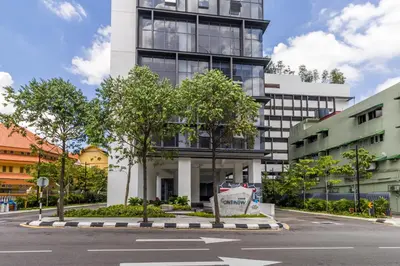 a building with trees in front of a street at Continew Residensi by Airhost in Kuala Lumpur