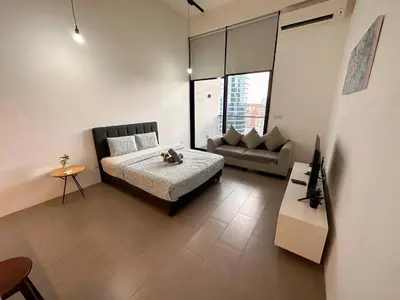 a bedroom with a bed and a couch in it at KL Sentral Loft, EST Bangsar #6, LRT in Kuala Lumpur