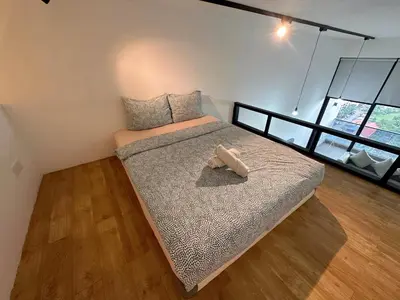 a bedroom with a bed with a stuffed animal on it at KL Sentral Loft, EST Bangsar #6, LRT in Kuala Lumpur