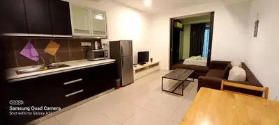 a kitchen and living room with a couch and a table at Taragon BBCC in Kuala Lumpur