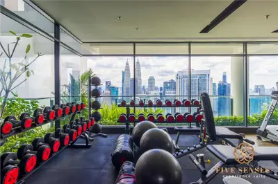 a gym with a view of the city at The Colony & The Luxe, Kuala Lumpur by Canopy Lives in Kuala Lumpur