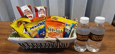 a basket of snacks and water bottles on a table at Fahenheit 88, Kuala Lumpur 17 in Kuala Lumpur