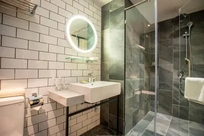 a bathroom with a sink and a shower at Santa Grand Signature Kuala Lumpur in Kuala Lumpur