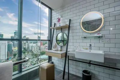 a bathroom with a sink and a mirror at Santa Grand Signature Kuala Lumpur in Kuala Lumpur