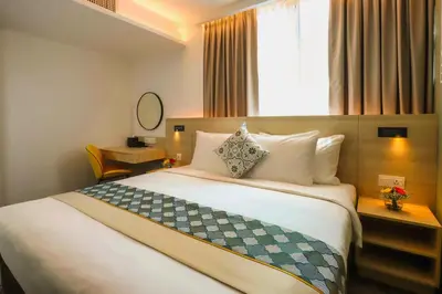 a hotel room with a large bed and a window at Santa Grand Signature Kuala Lumpur in Kuala Lumpur