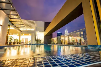 a swimming pool in a building with a view of the city at Santa Grand Signature Kuala Lumpur in Kuala Lumpur