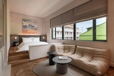 a living room with a couch and a bed at Else Kuala Lumpur, a member of Design Hotels in Kuala Lumpur