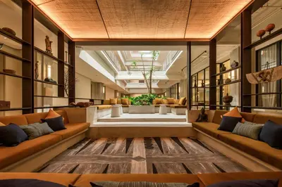 a living room with couches and a large window at Else Kuala Lumpur, a member of Design Hotels in Kuala Lumpur