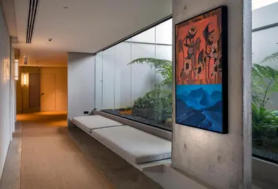 a hallway with a large painting on the wall at Else Kuala Lumpur, a member of Design Hotels in Kuala Lumpur