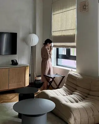 a woman standing in a living room talking on a cell phone at Else Kuala Lumpur, a member of Design Hotels in Kuala Lumpur