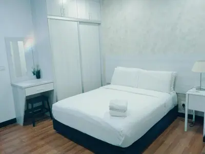 a white bedroom with a bed and a desk at Mercu Summer Suites KLCC by Star Residence in Kuala Lumpur