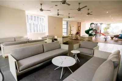 a large living room with couches and tables in it at 188 Suites KLCC by Signature Apartment in Kuala Lumpur