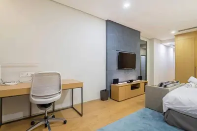 a bedroom with a desk and a bed and a chair at 188 Suites KLCC by Signature Apartment in Kuala Lumpur